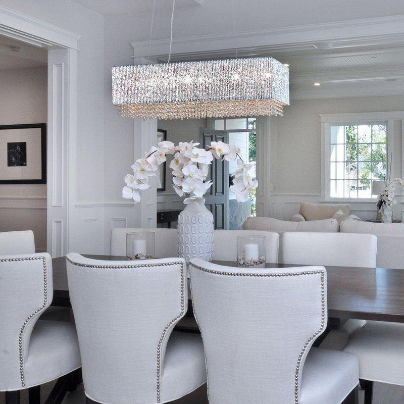 linear crystal chandelier hanging in neutral colored dining room
