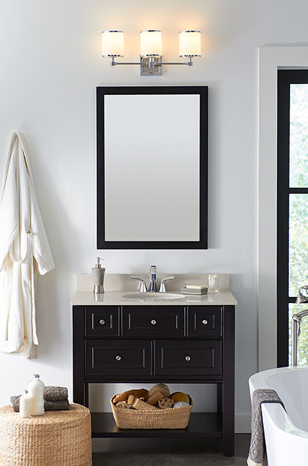 one transitional 3-light bath vanity light hung over mirror