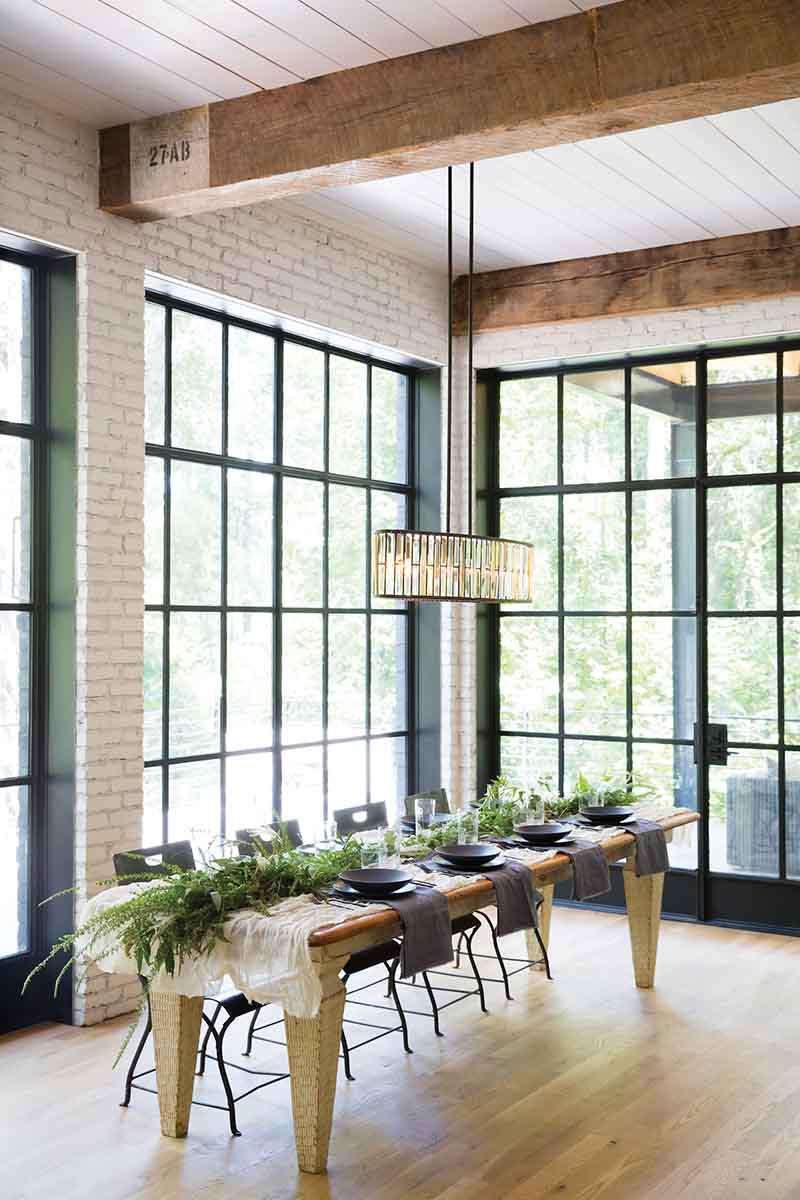 modern linear crystal chandelier hanging over dining table