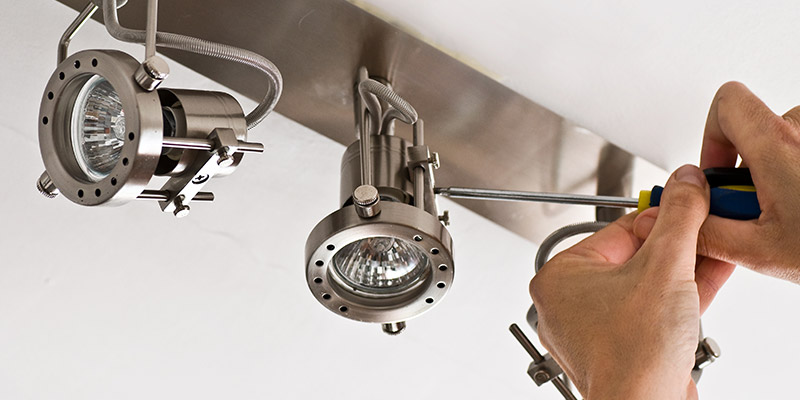 person installing track lighting kit