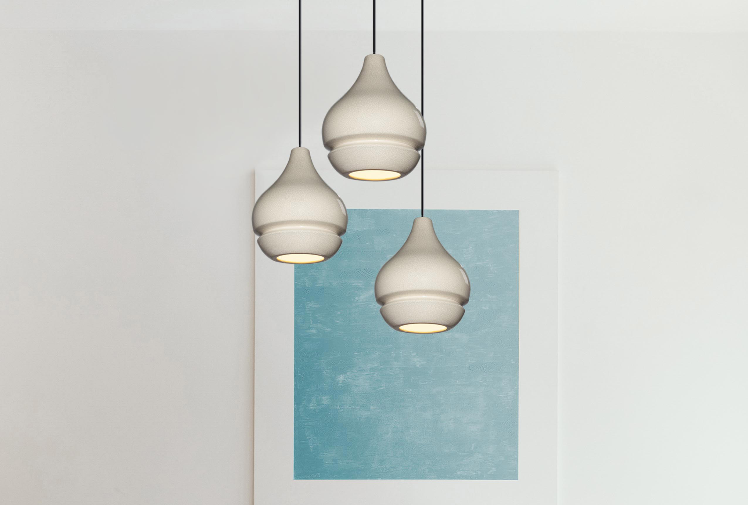 three ceramic pendants hung in a cluster