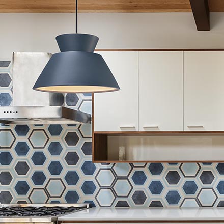 transitional blue ceramic pendant light hanging over kitchen island
