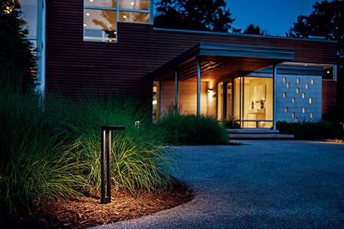 1 pathway light next to driveway at night