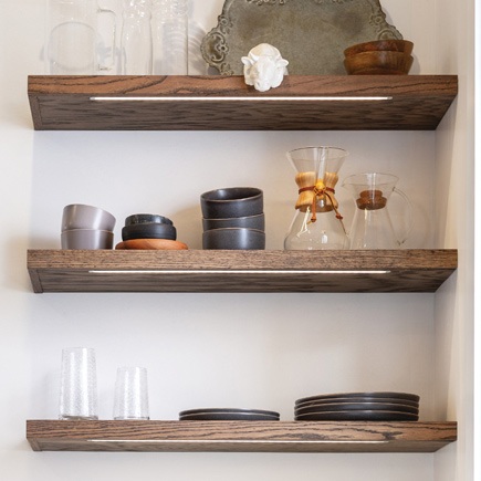 three under cabinet led tape lights under open shelving in kitchen