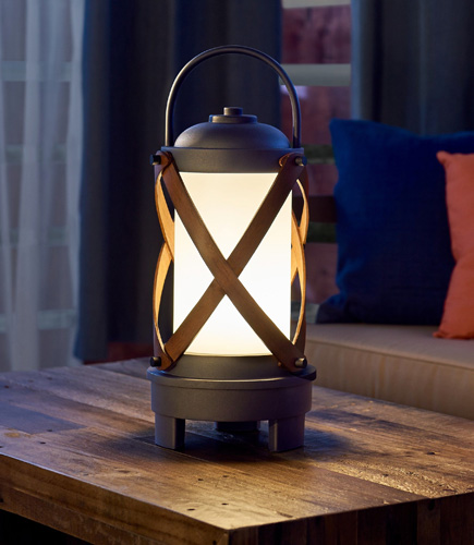 portable led lantern on coffee table outside