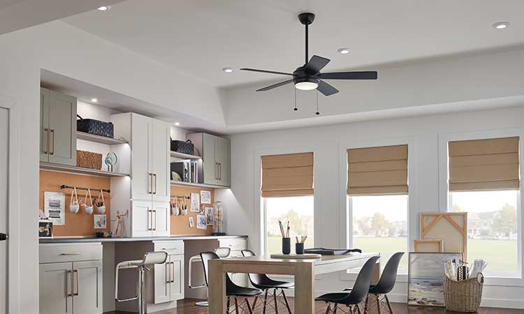  one black ceiling fan with light kit hanging in the center of an office