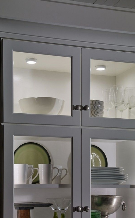 under cabinet puck lights in each shelf of a cabinet