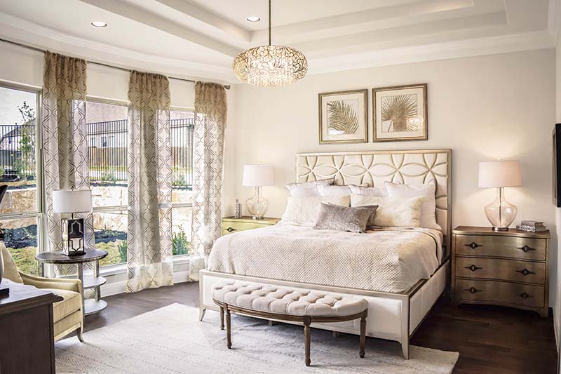patterned metal and crystal chandelier hanging in bedroom