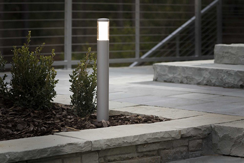 one led bollard light in landscape next to stairs