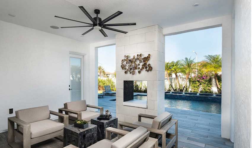one 8-blade modern outdoor ceiling fan hanging above patio furniture set 