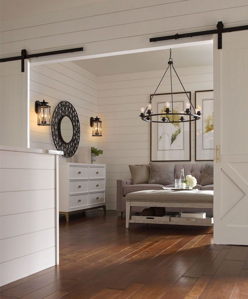 nine light chandelier hanging over coffee table