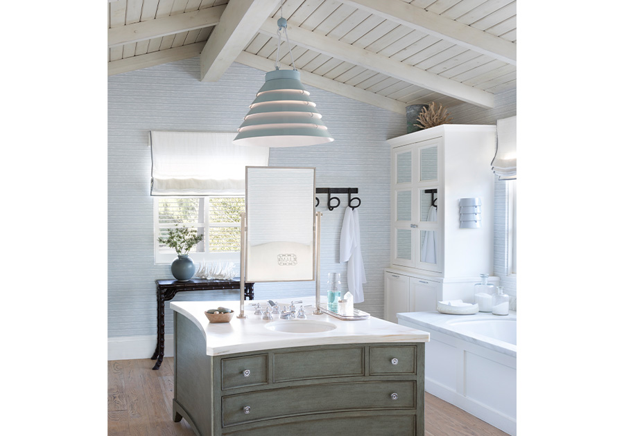 one metal coastal pendant light hanging over bathroom vanity