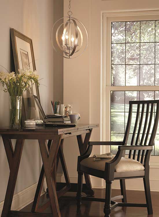  3-light pendant light hanging above wooden desk