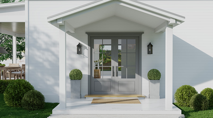 two black outdoor wall sconces hanging on either side of front door of a house