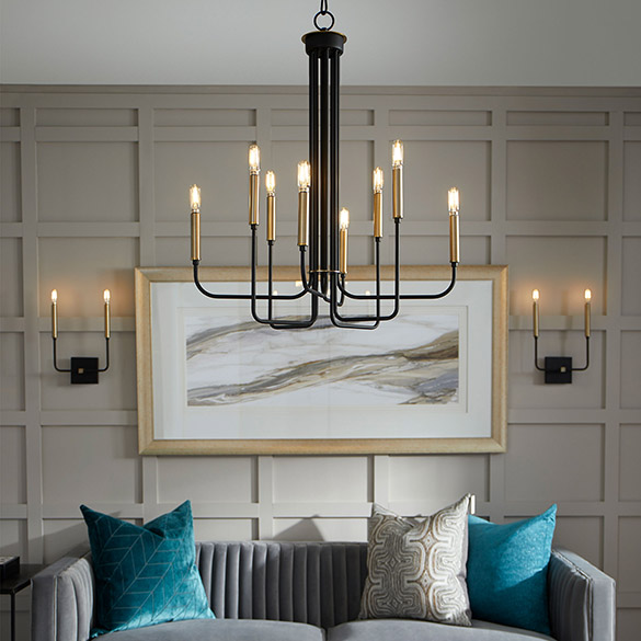 Modern living room scene with gray velour vertically tufted couch, turquoise throw pillows, gray board and batten wall with a large framed modern painting flanked by a dual sconce on either side, white ceiling from which hangs a Quorum Lighting Hope 630-8-6980 contemporary chandelier