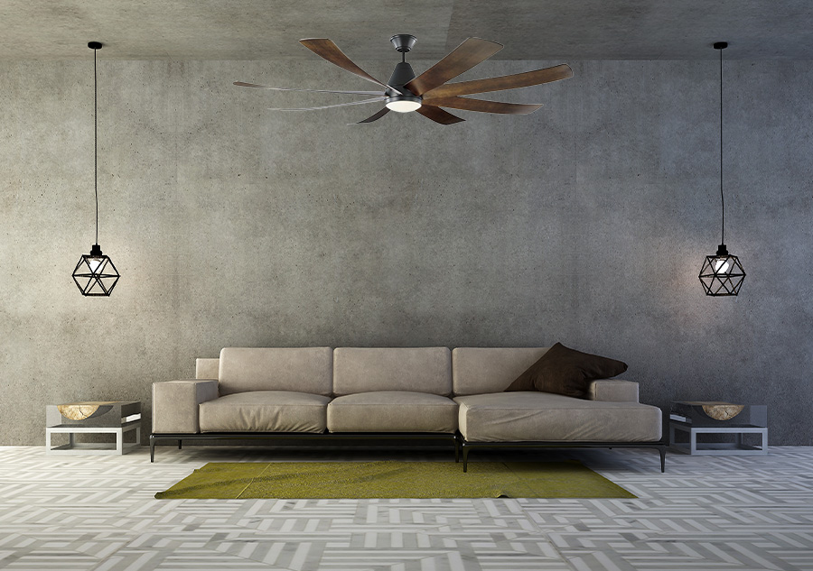 Industrial looking living room with concrete walls, geometric gray patterned carpet and beige couch with geometric cage lighting and Visual Comfort Fan Collection Kingston modern matte black outdoor ceiling fan with slightly curved dark walnut blades