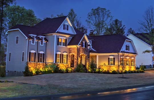 wide view of house and landscape in evening setting