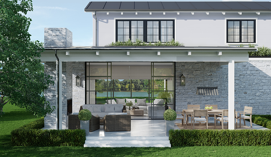 Exterior shot looking at modern farmhouse home with white patio floor, rattan furniture with white cushions in front of a white stone fireplace, neutral-colored area rug under a six-person wooden dining set with white cushions, white stone exterior to the first floor of the house, huge floor-to-ceiling sliding glass doors into the home, white covered roof from which hangs a Progress Lighting Edgecliff P550119-141 outdoor hanging pendant over the dining table