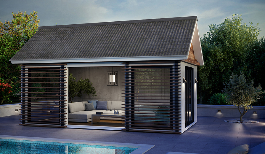 Outdoor view of pool house next to pool in early evening, pool has styled concrete surround, pool house has slats on all floor-to-ceiling windows, gray L-shaped couch, wood coffee table, gray paneled walls, two potted trees and has a Progress Lighting Shademore P550118-31M pendant light