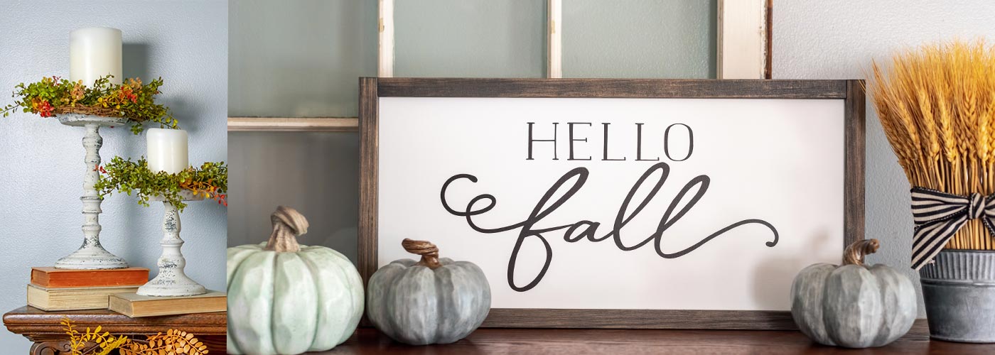 fall home decor with pumpkins, white distressed candlesticks, and a wood sign that says hellow fall